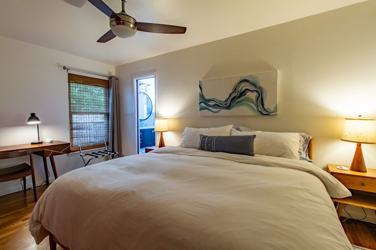 Primary bedroom with King size bed, desk and ensuite bath